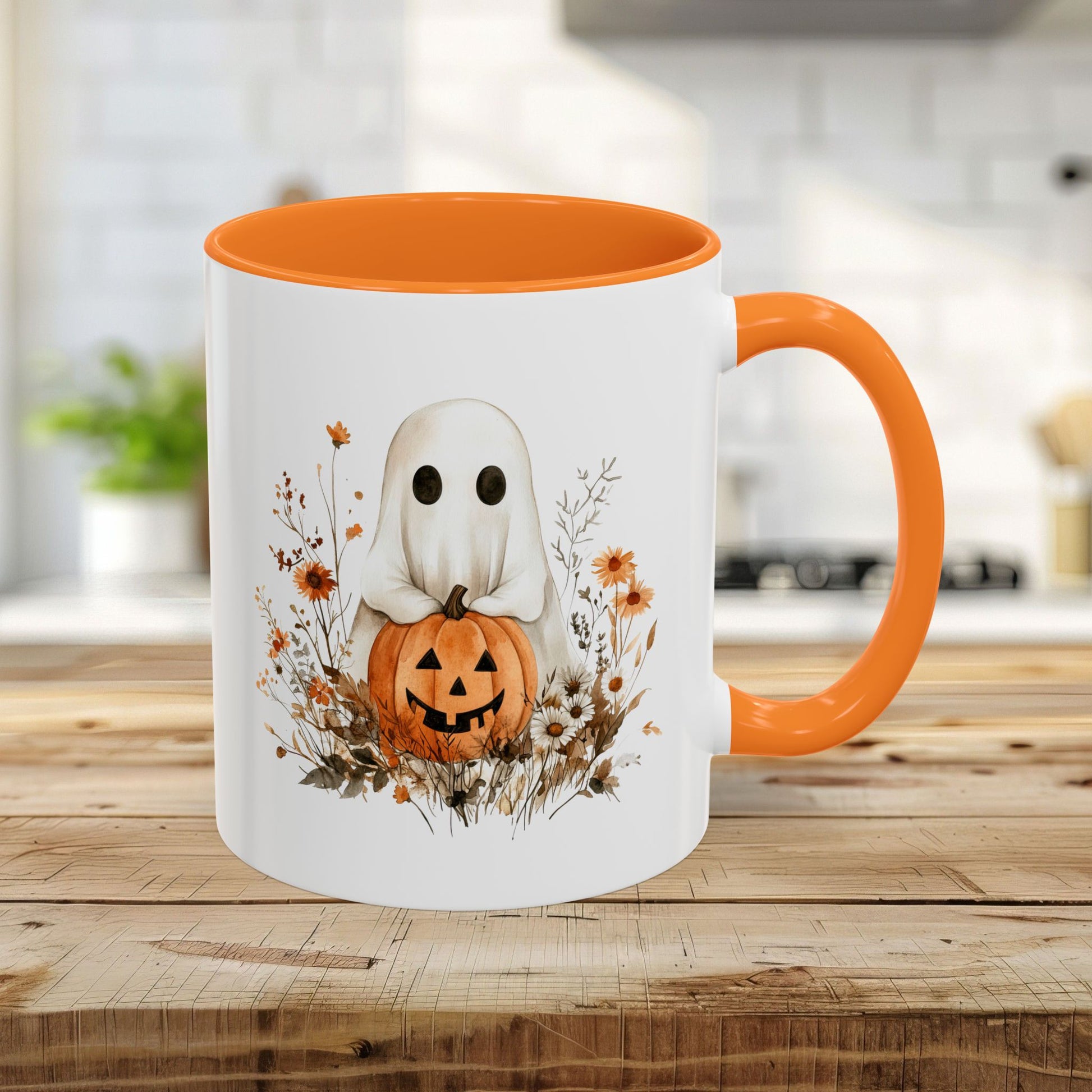 White 11oz ceramic mug with orange handle and interior, featuring a watercolor ghost holding a jack-o'-lantern amidst wildflowers.