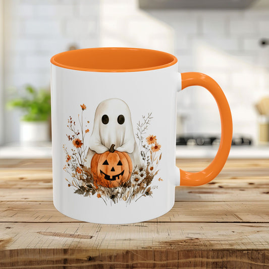 White 11oz ceramic mug with orange handle and interior, featuring a watercolor ghost holding a jack-o'-lantern amidst wildflowers.