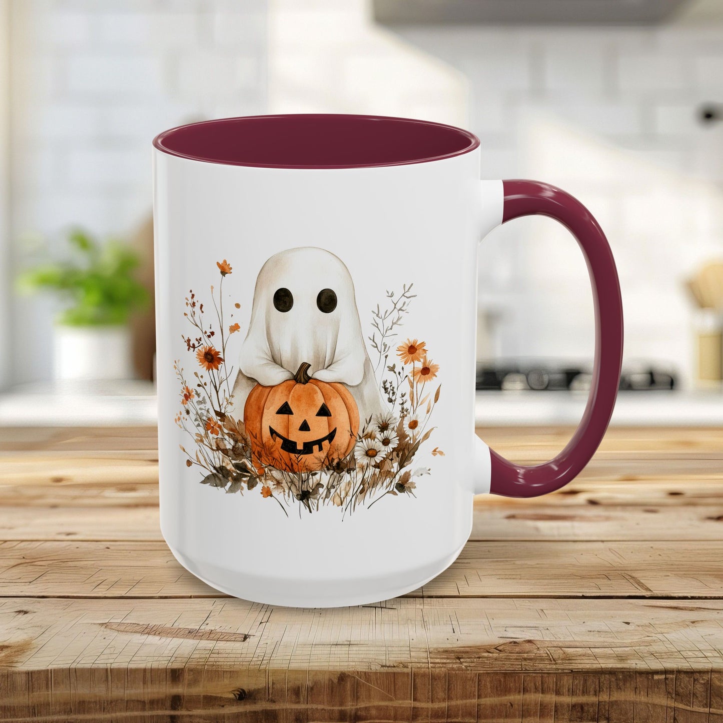 15oz ceramic mug with a maroon handle and interior, featuring a whimsical watercolor ghost holding a jack o'lantern.