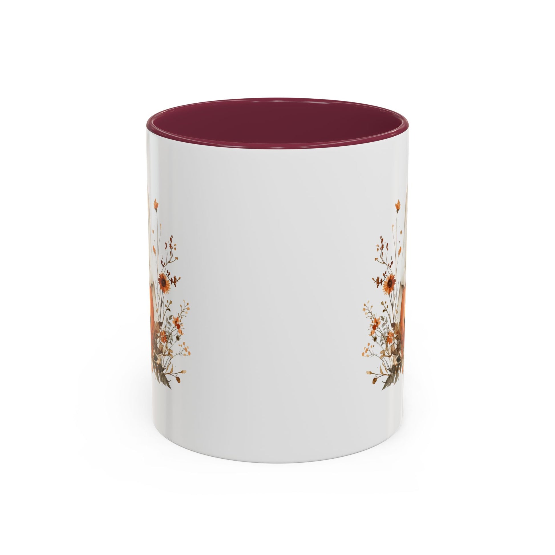 White ceramic mug with a dark red interior and handle, featuring a boho ghost on a jack-o'-lantern with wildflowers.
