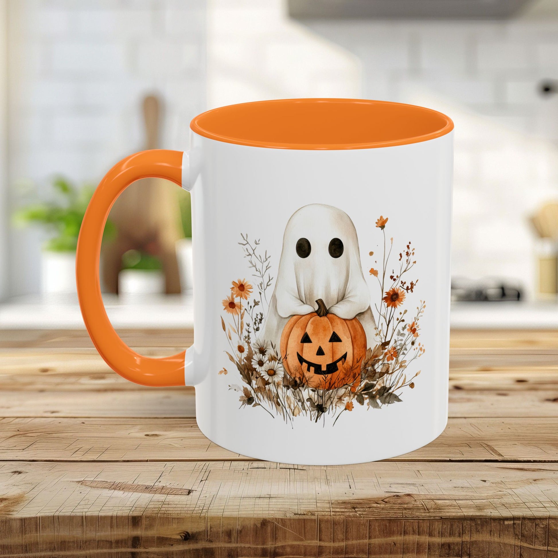 White ceramic mug with orange handle and interior, featuring a watercolor ghost holding a jack-o'-lantern amidst wildflowers.