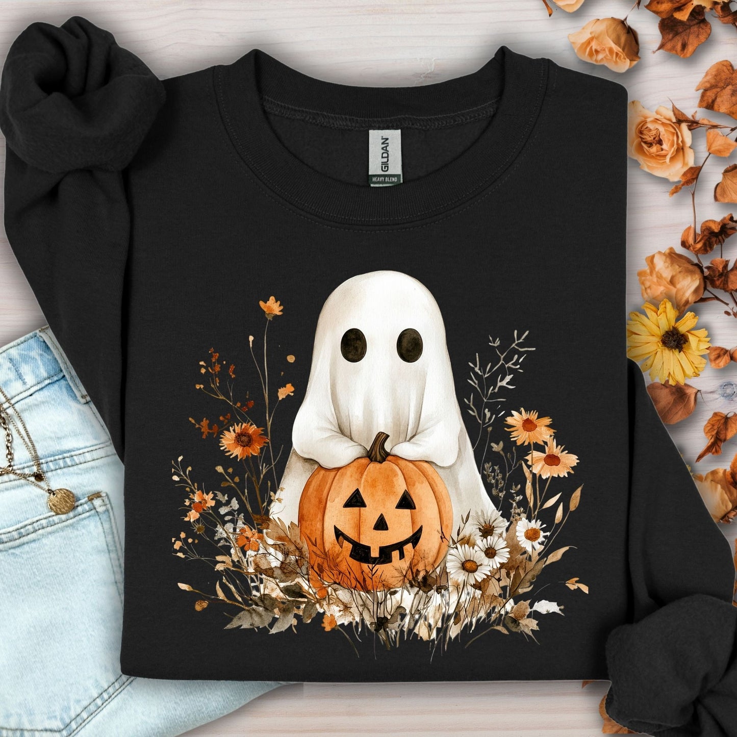 Black Halloween Boho Ghost with Jack O'Lantern sweatshirt, surrounded by autumn wildflowers.