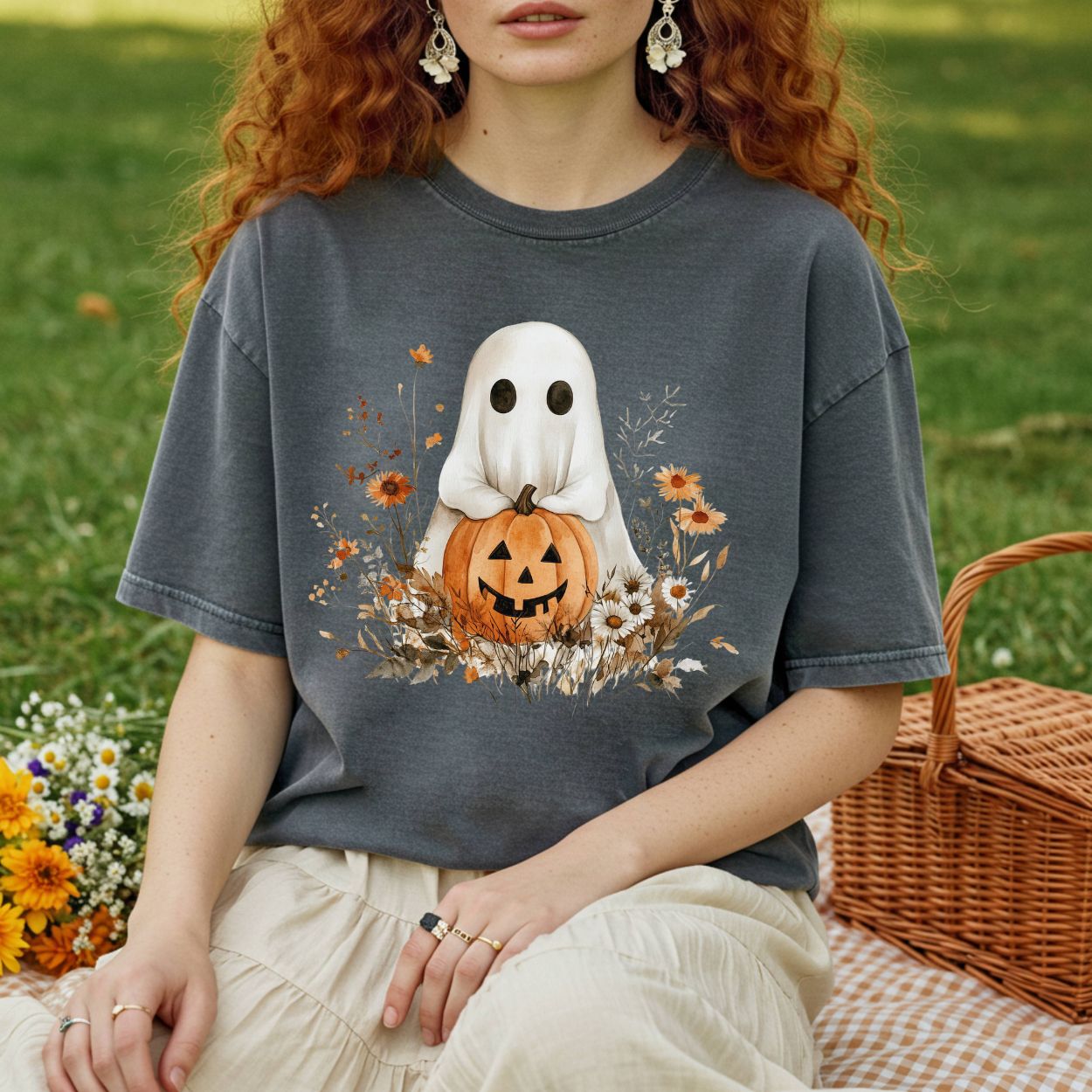 Charcoal gray Halloween Boho Ghost t-shirt with a jack o'lantern and autumn florals, worn by a person outdoors.