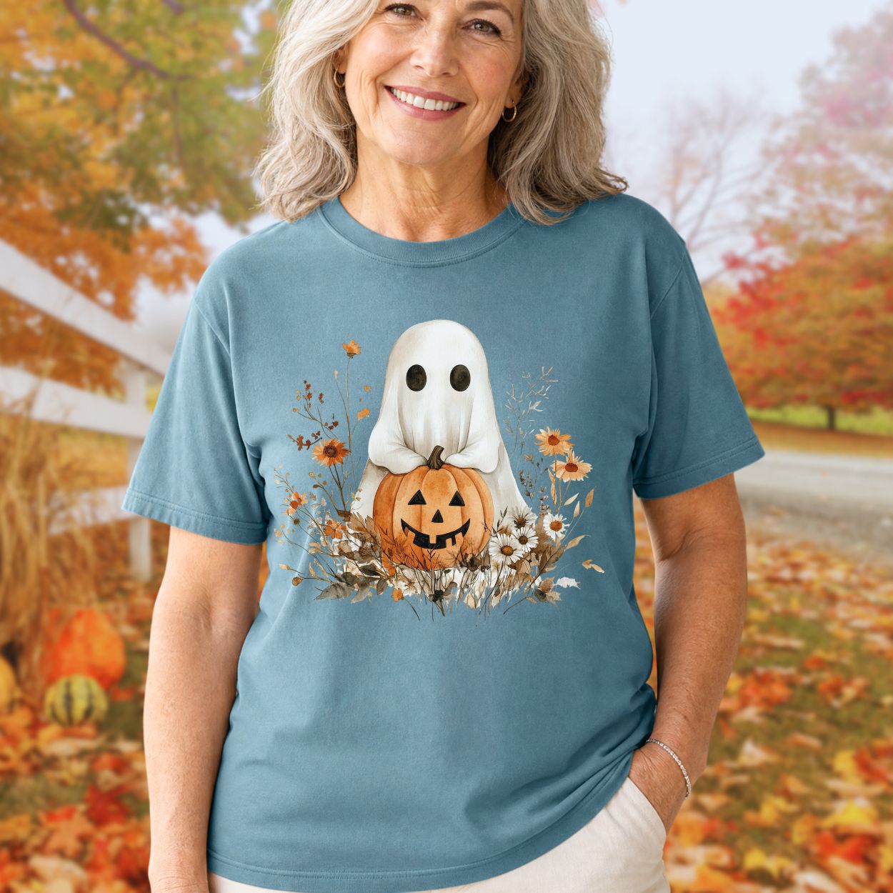 Boho ghost with jack o'lantern and autumn florals on a relaxed-fit, garment-dyed blue cotton t-shirt.