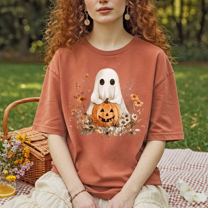 Boho ghost t-shirt in muted orange, featuring a ghost holding a jack-o'-lantern with autumn florals.