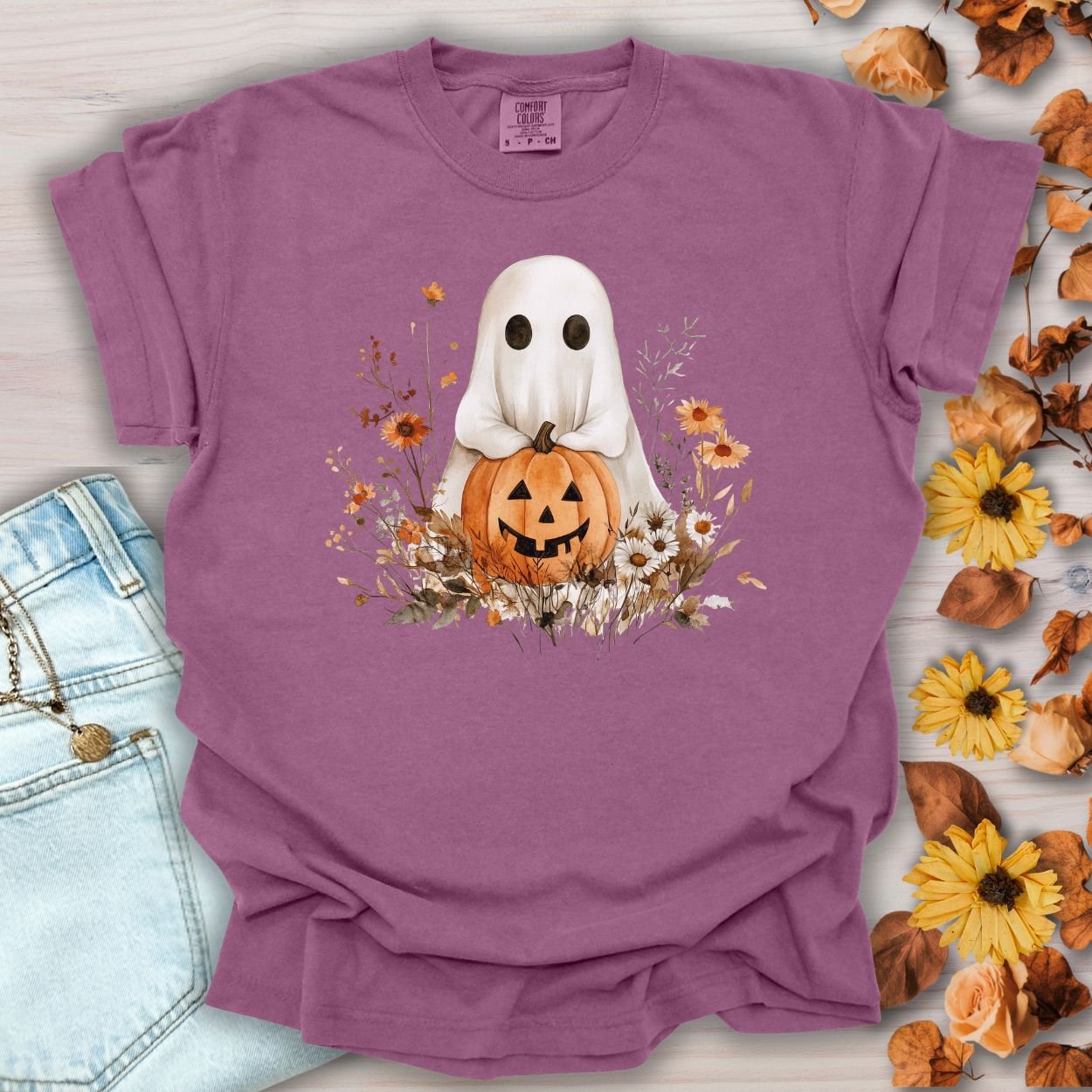 Berry garment-dyed cotton t-shirt with a boho ghost holding a jack-o'-lantern surrounded by autumn florals.
