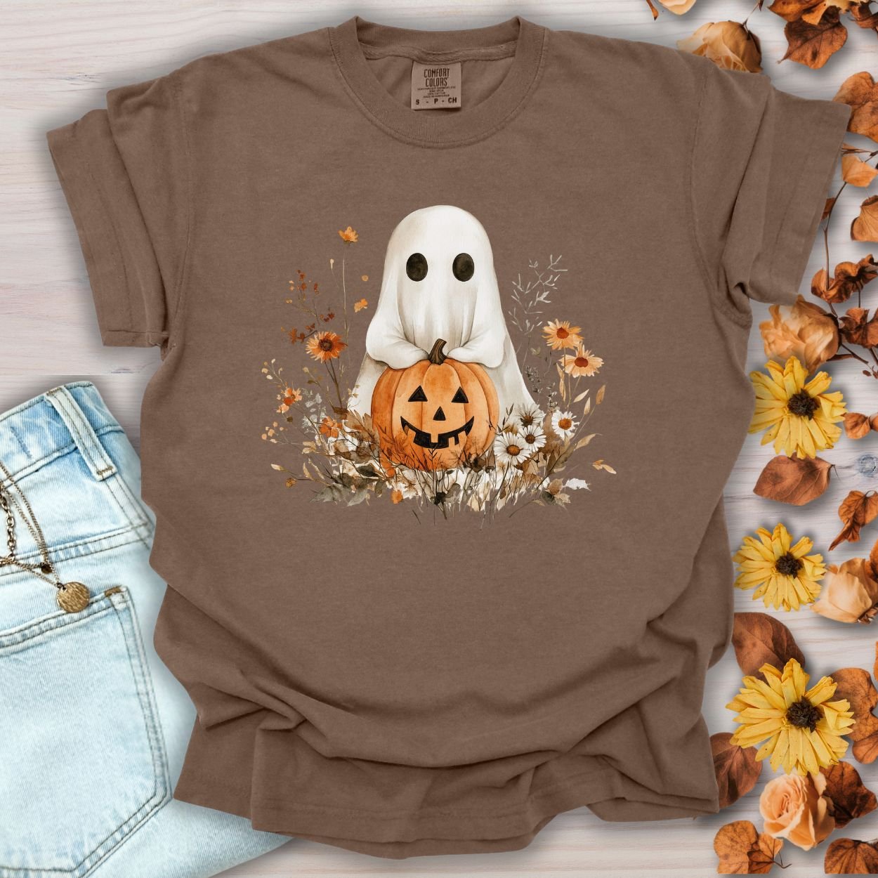 Espresso cotton t-shirt with a boho ghost holding a jack-o'-lantern, surrounded by autumn florals.