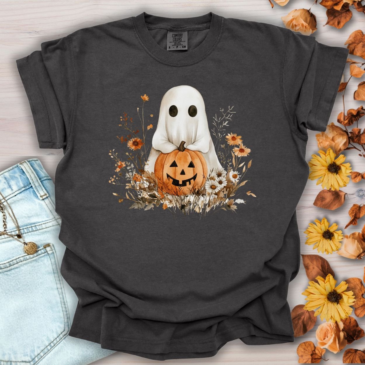 Pepper-colored cotton t-shirt with a boho ghost holding a jack-o'-lantern, surrounded by autumn florals.