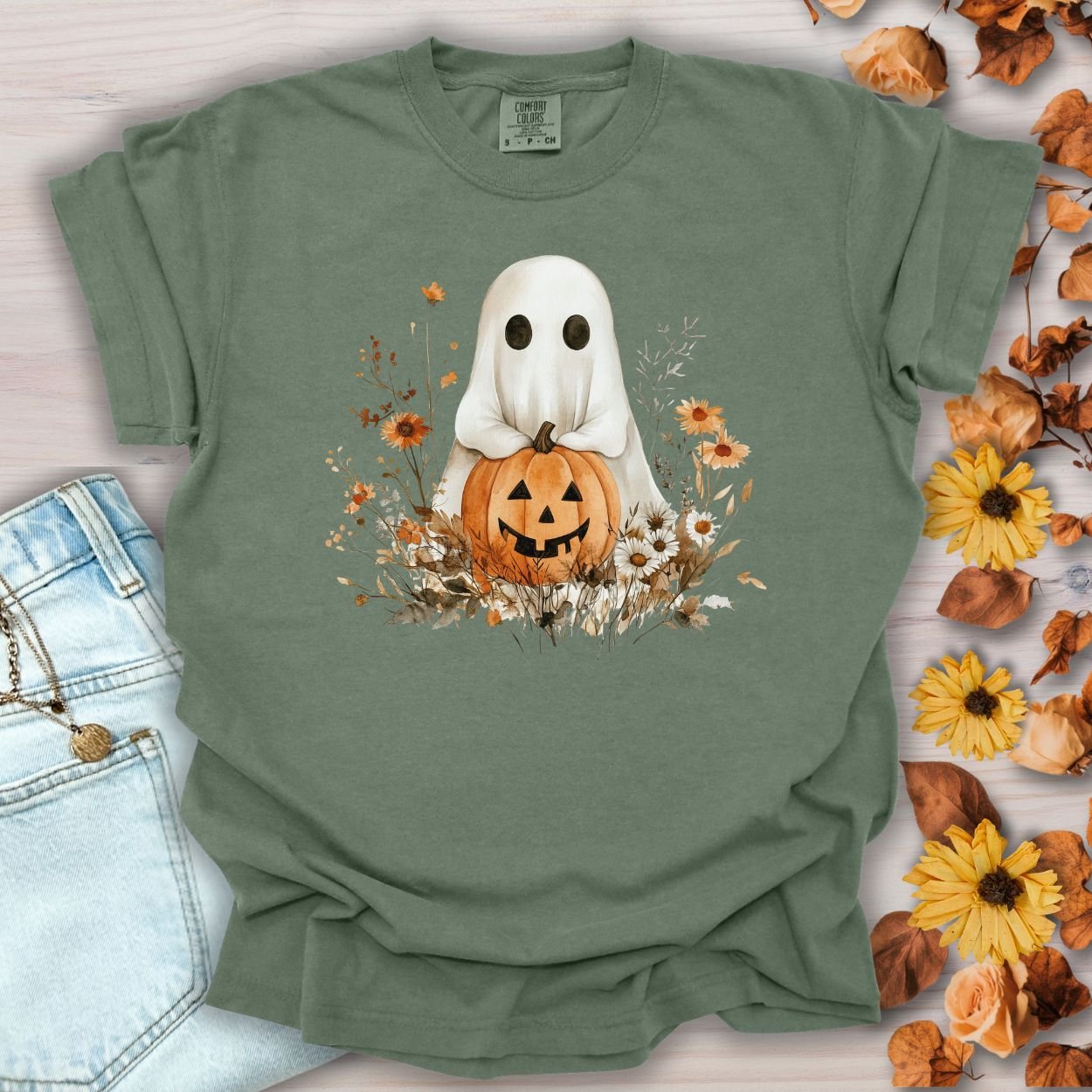Moss green cotton t-shirt with a boho ghost holding a jack o'lantern, surrounded by autumn florals.