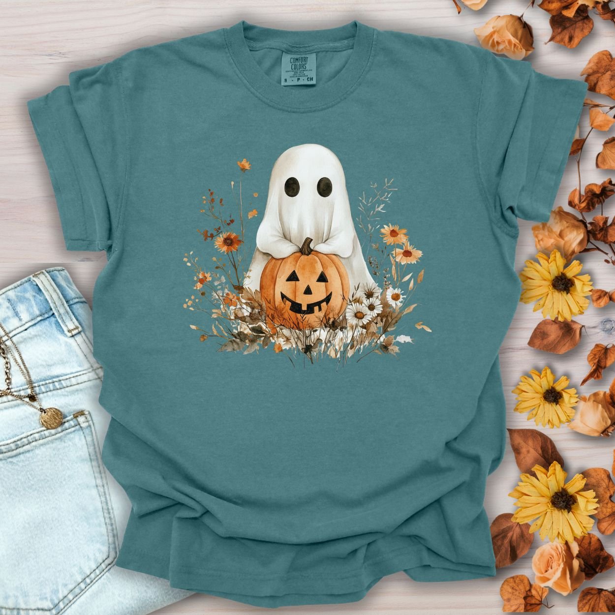 Blue Spruce cotton t-shirt with a boho ghost holding a jack o'lantern, surrounded by autumn florals.