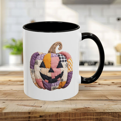 Black 11oz ceramic mug with a quilted patchwork jack-o'-lantern design.