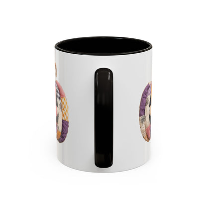 White ceramic mug with black handle and interior, featuring a quilted patchwork jack-o'-lantern design.