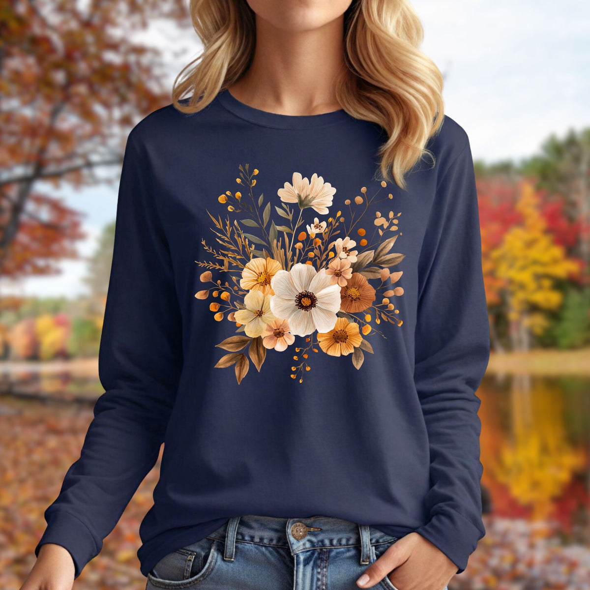 Navy long-sleeve tee with a cottagecore autumn floral design, worn by a woman outdoors.