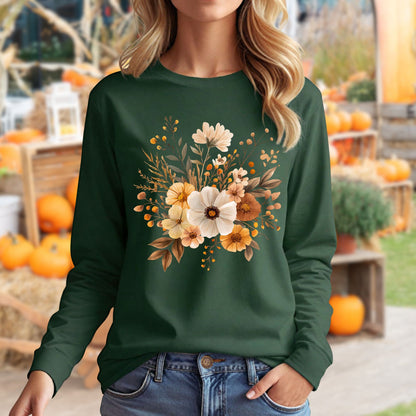 Woman in a dark green long-sleeve tee with a muted autumn floral design, paired with jeans.