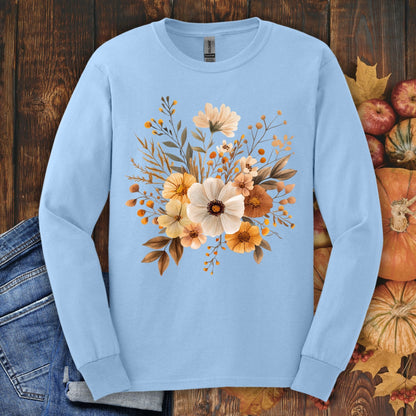 Light blue Gildan long sleeve tee with a muted autumn floral design, surrounded by fall leaves and pumpkins.