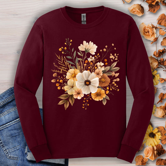 Maroon long-sleeve cotton tee with a cottagecore design of muted autumn flowers, shown with jeans.