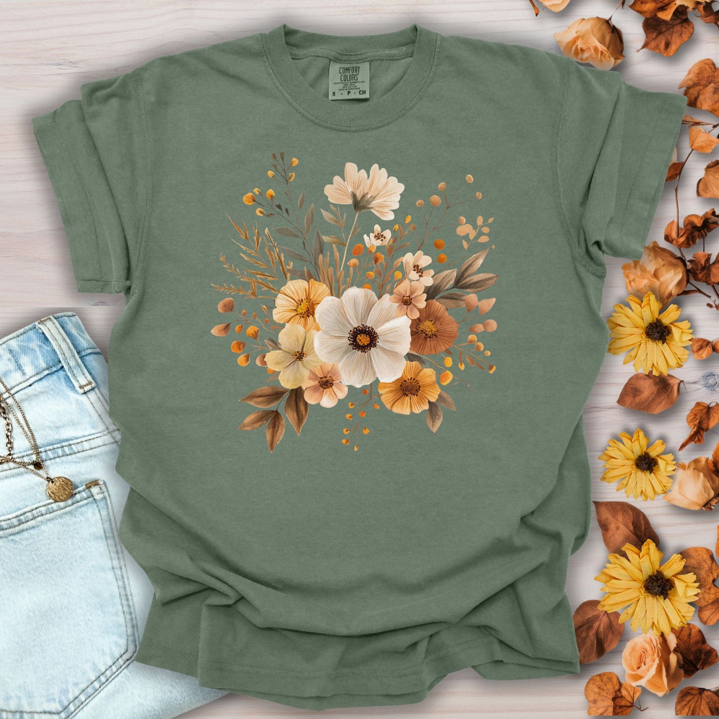 Moss green garment-dyed t-shirt with a warm bouquet of autumn-hued blooms at the chest.