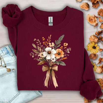Maroon sweatshirt with a watercolor-inspired harvest floral bouquet tied with a light brown bow.