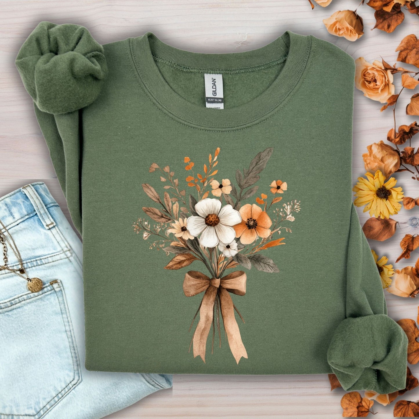 Military green sweatshirt with a watercolor harvest bouquet tied with a light brown bow.