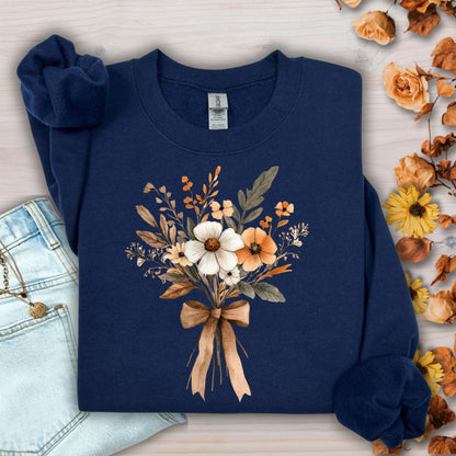 Navy unisex sweatshirt with a watercolor harvest bouquet of white, orange, and brown flowers tied with a light brown bow.