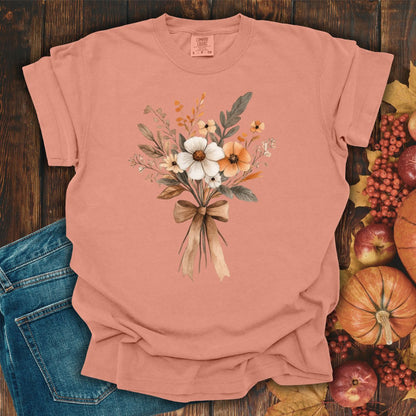 Terracotta Harvest Bouquet T-shirt with watercolor fall flowers and a bow, made from garment-dyed cotton.