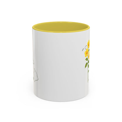 White ceramic mug with yellow hibiscus flowers, a Hawaii outline, and a yellow interior.
