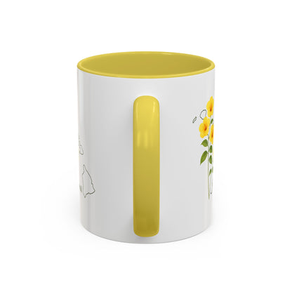 White ceramic mug with yellow interior and handle, featuring a yellow hibiscus design and Hawaii outline.