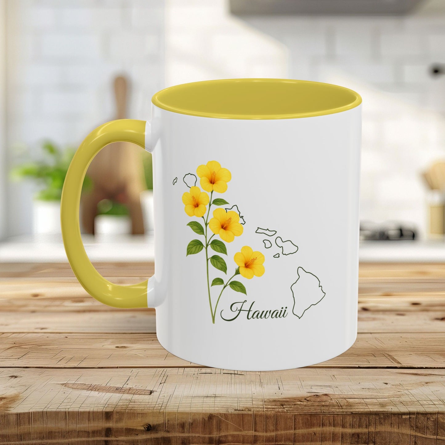 White ceramic mug with yellow hibiscus flowers, a Hawaii map outline, and a yellow interior/handle on a wooden table.