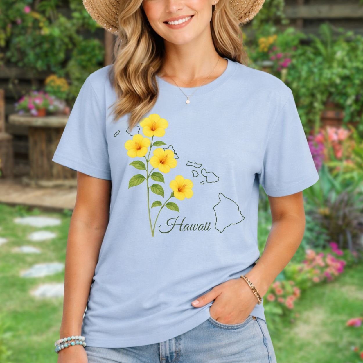Woman in a light blue t-shirt with yellow hibiscus flowers and a Hawaii map outline.