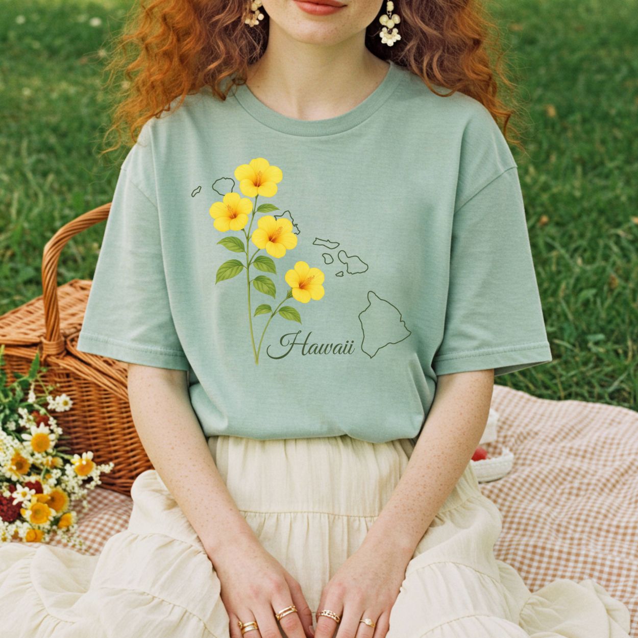 Relaxed-fit, garment-dyed tee in faded coral with yellow hibiscus and Hawaiian island outline.