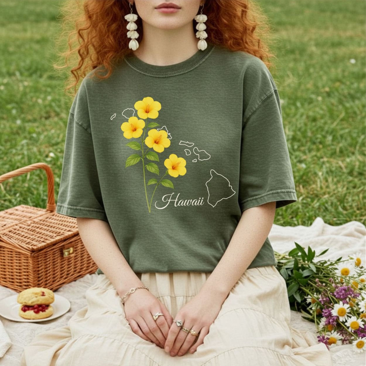 Garment-dyed olive green t-shirt with yellow hibiscus flowers and a white outline of the Hawaiian islands.
