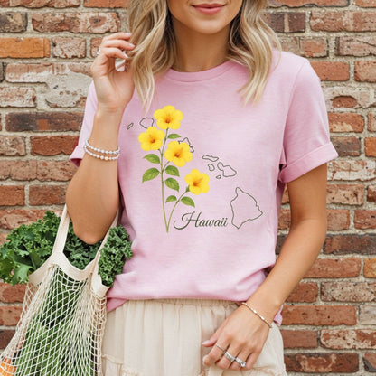 Relaxed-fit, garment-dyed pink t-shirt with yellow hibiscus flowers and Hawaii island outline.