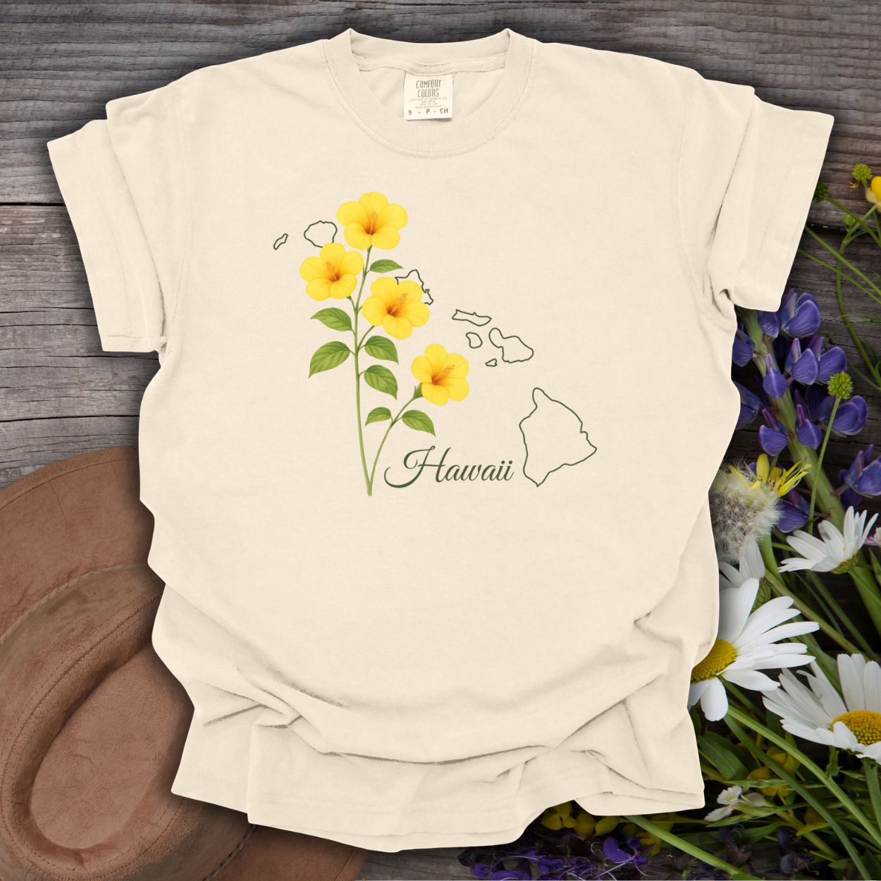 Ivory relaxed-fit t-shirt with yellow hibiscus flowers, "Hawaii" script, and island outline.