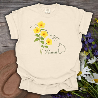 Ivory relaxed-fit t-shirt with yellow hibiscus flowers, "Hawaii" script, and island outline.