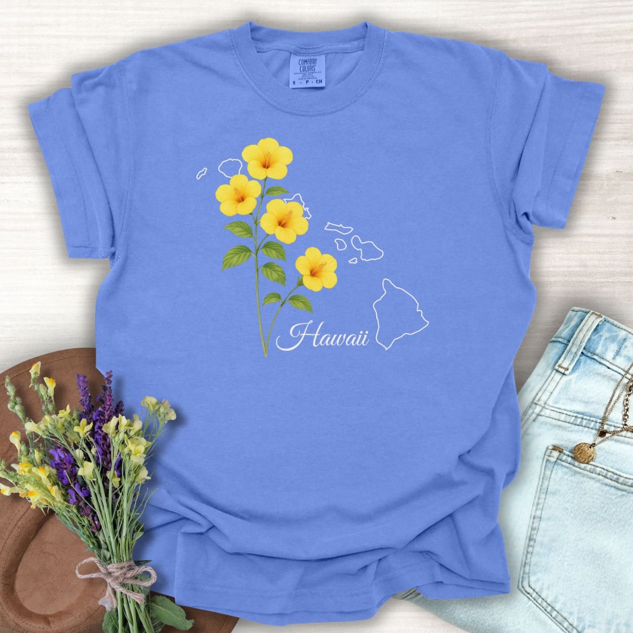 Periwinkle S t-shirt with yellow hibiscus flowers and a white outline of the Hawaiian islands.