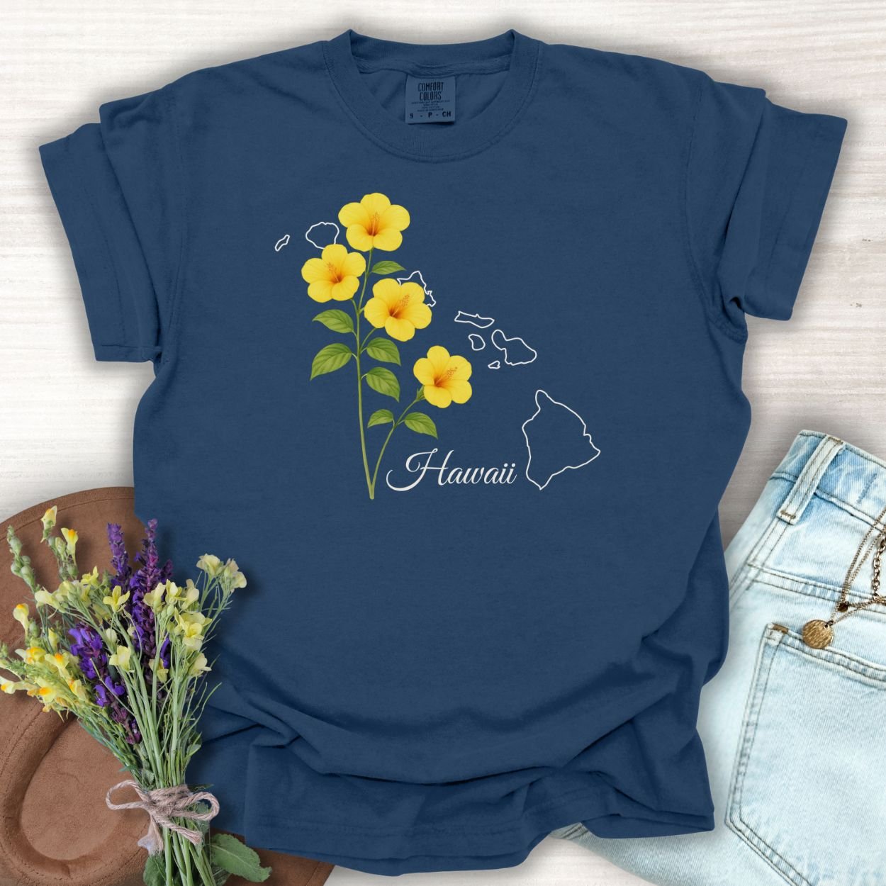 True Navy S-size t-shirt with yellow hibiscus flowers, "Hawaii" text, and island outline.