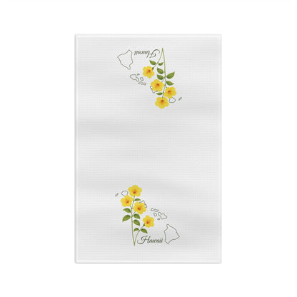 White microfiber tea towel with yellow hibiscus flowers and a subtle Hawaii island map outline.