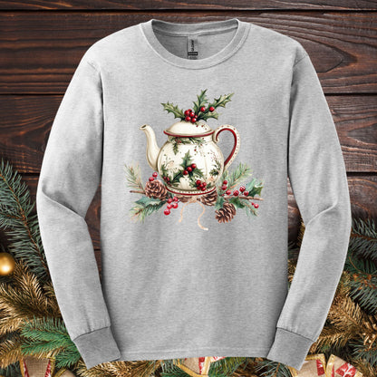 Ash long-sleeve tee with a watercolor Christmas teapot, holly, and pinecone design.