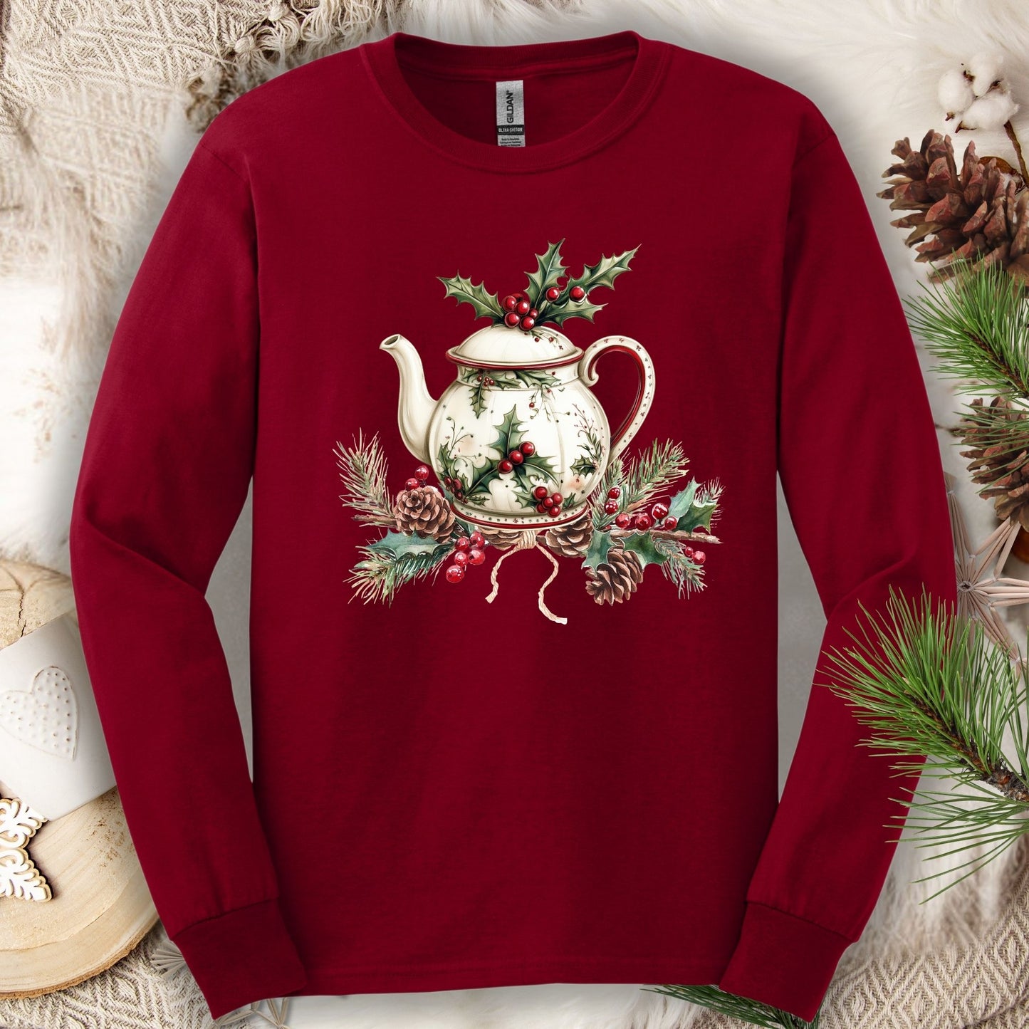 Cardinal Red long-sleeve tee with a watercolor Christmas teapot and holly design.