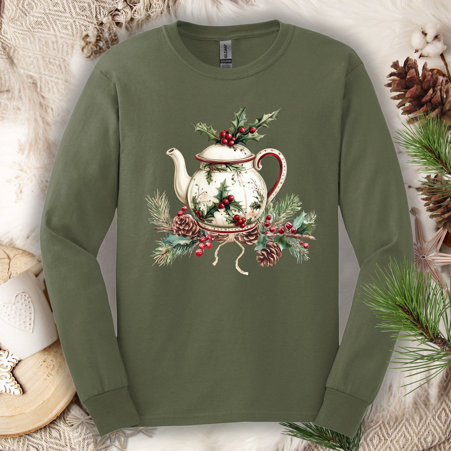 Military Green long-sleeve tee with a watercolor Christmas teapot and holly design.