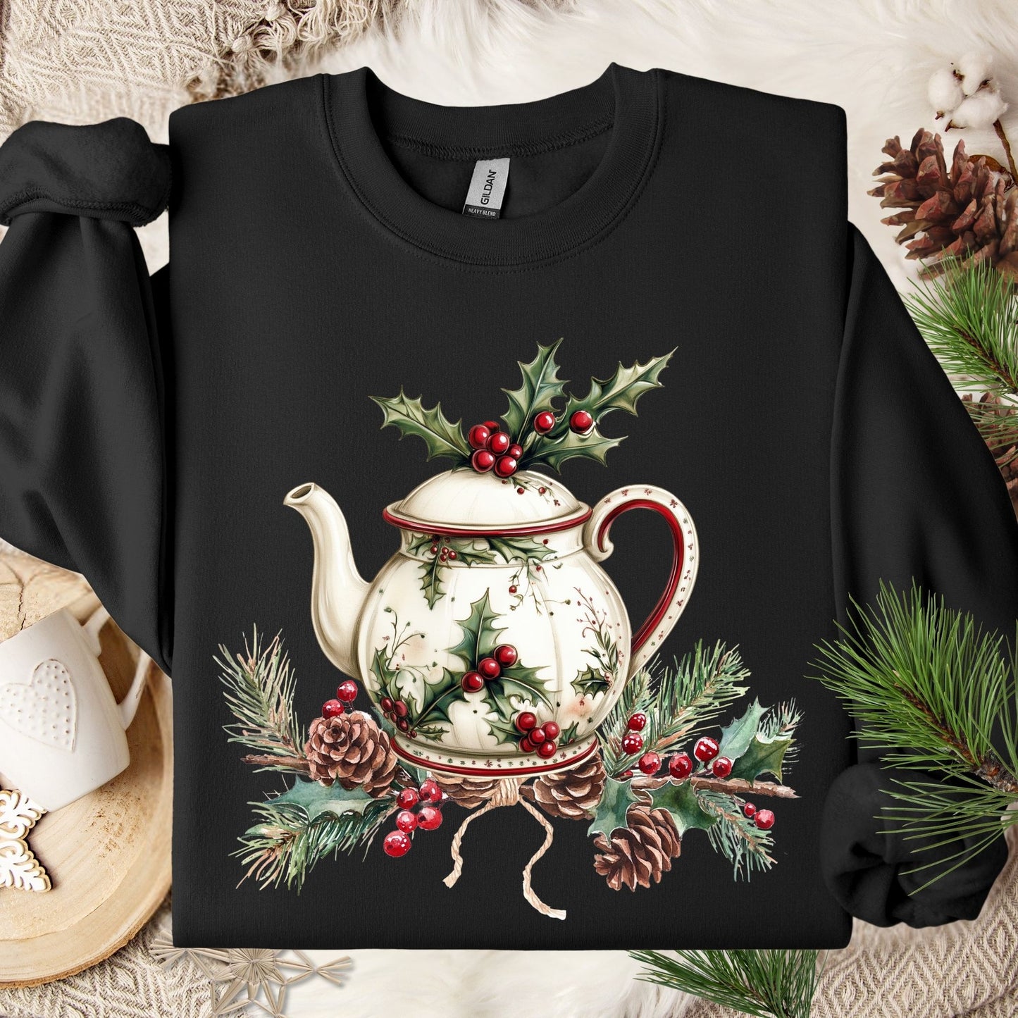 Black Gildan sweatshirt with a vintage Christmas teapot, holly, and pinecone design.