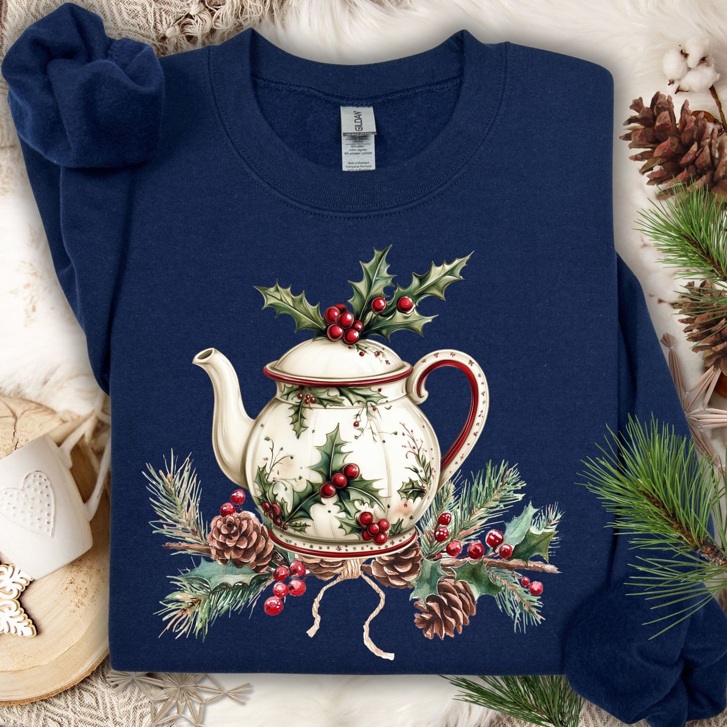 Navy Gildan sweatshirt with a vintage Christmas teapot, holly, and pinecone design.
