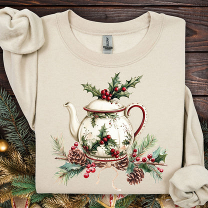 Sand Gildan sweatshirt with a vintage Christmas teapot, holly, and pinecone design.