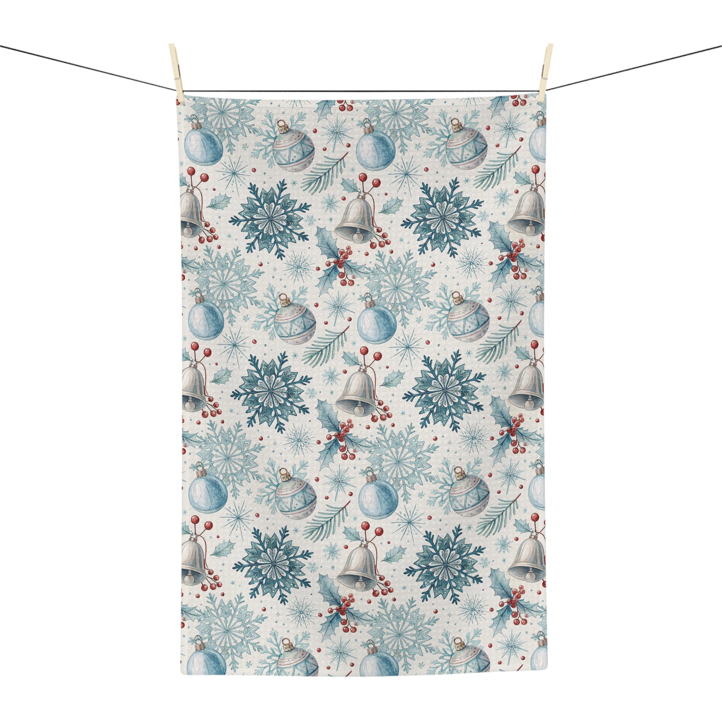Microfiber tea towel with a muted blue and silver holiday pattern of bells, snowflakes, and berries.