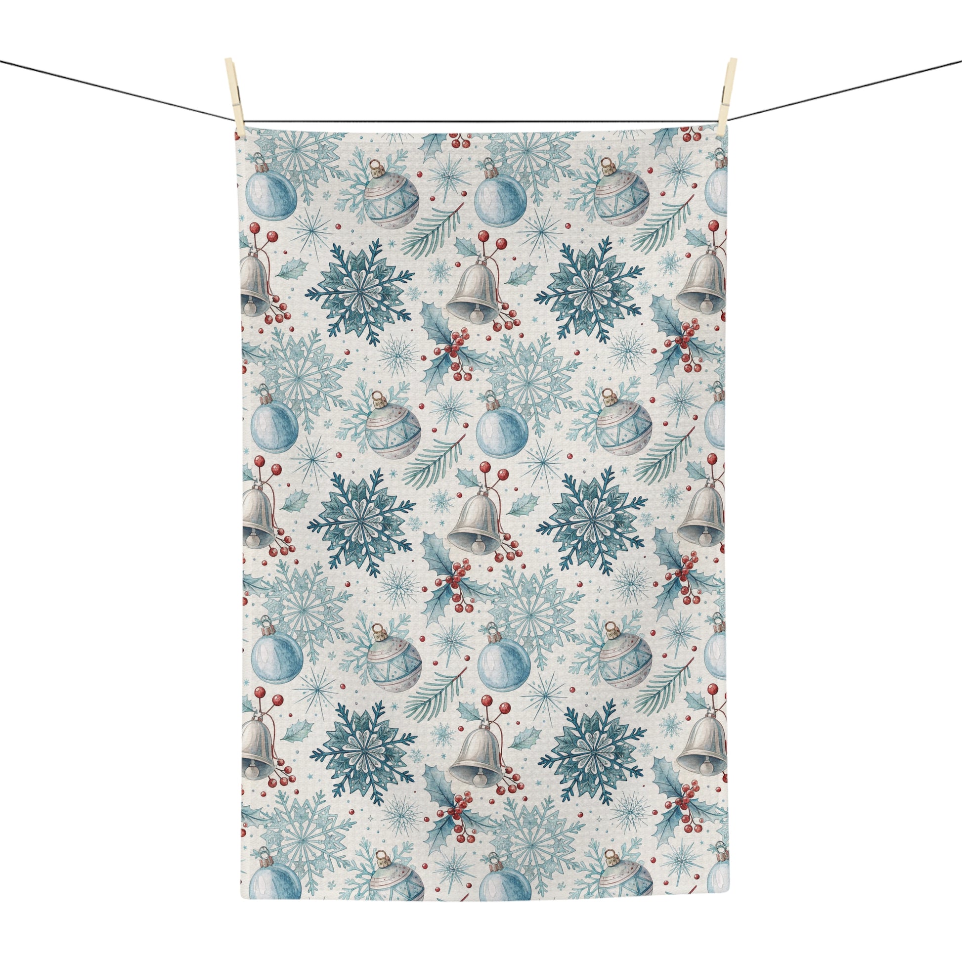 Microfiber tea towel with a muted blue and silver holiday pattern of bells, snowflakes, and berries.