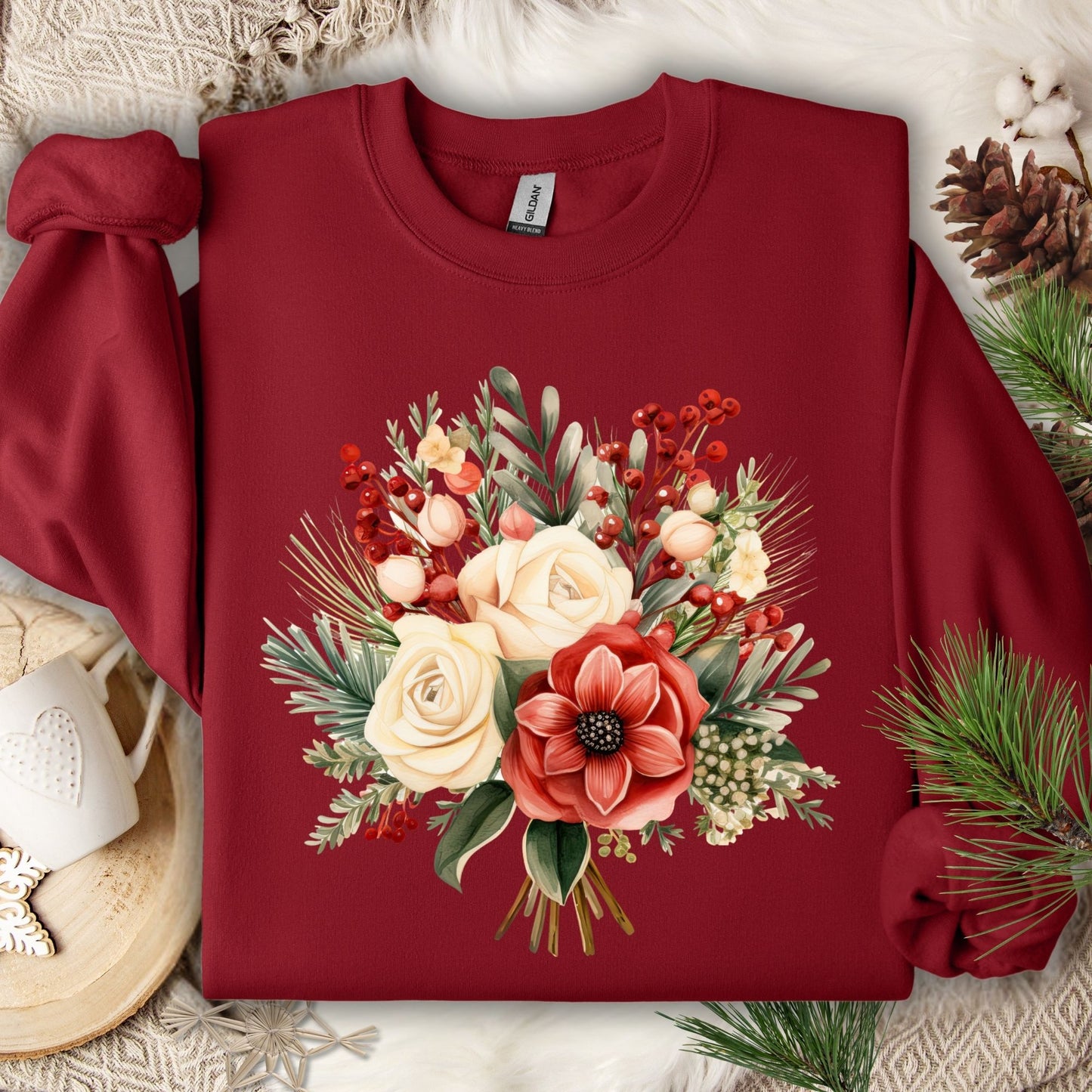 Garnet Gildan sweatshirt with a watercolor Christmas bouquet of red, cream, and green flowers and holly.