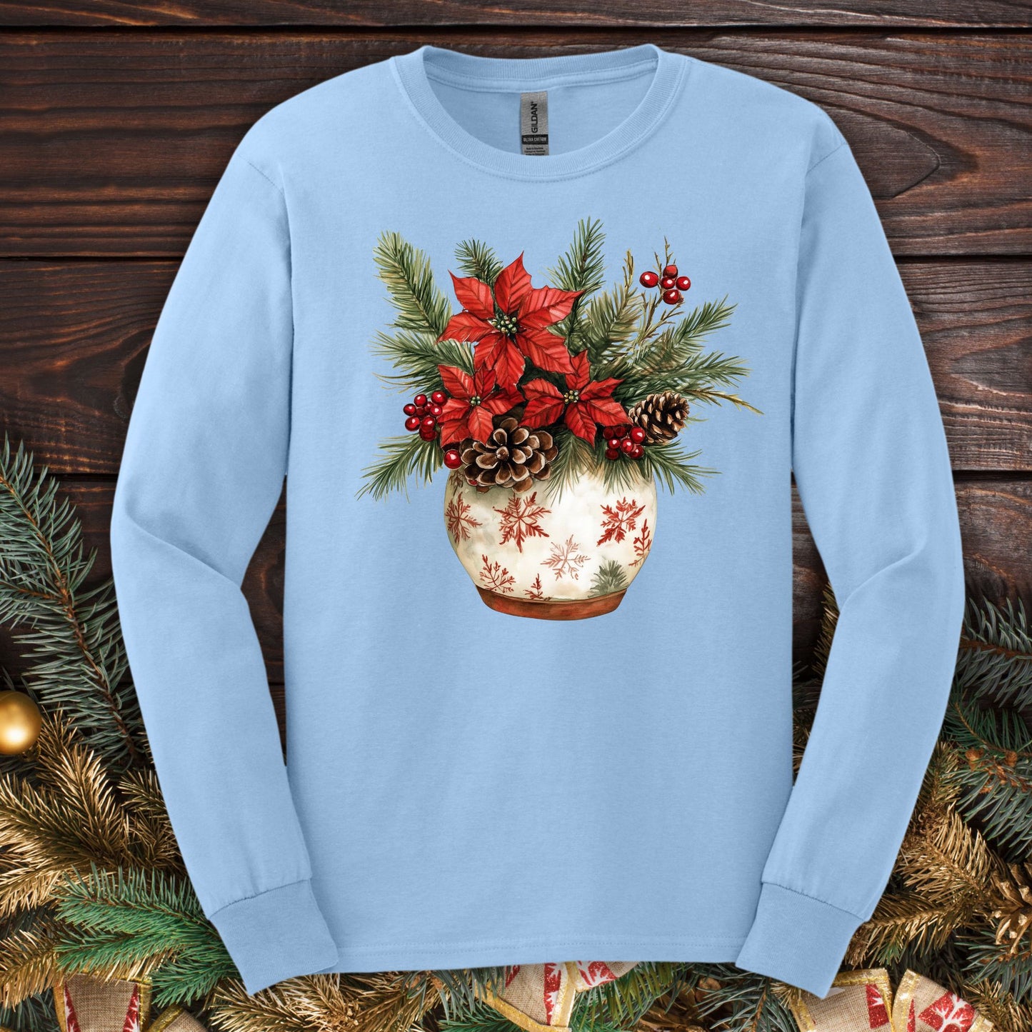 Light blue Gildan long sleeve tee with a watercolor holiday floral arrangement in a snowflake ceramic pot.
