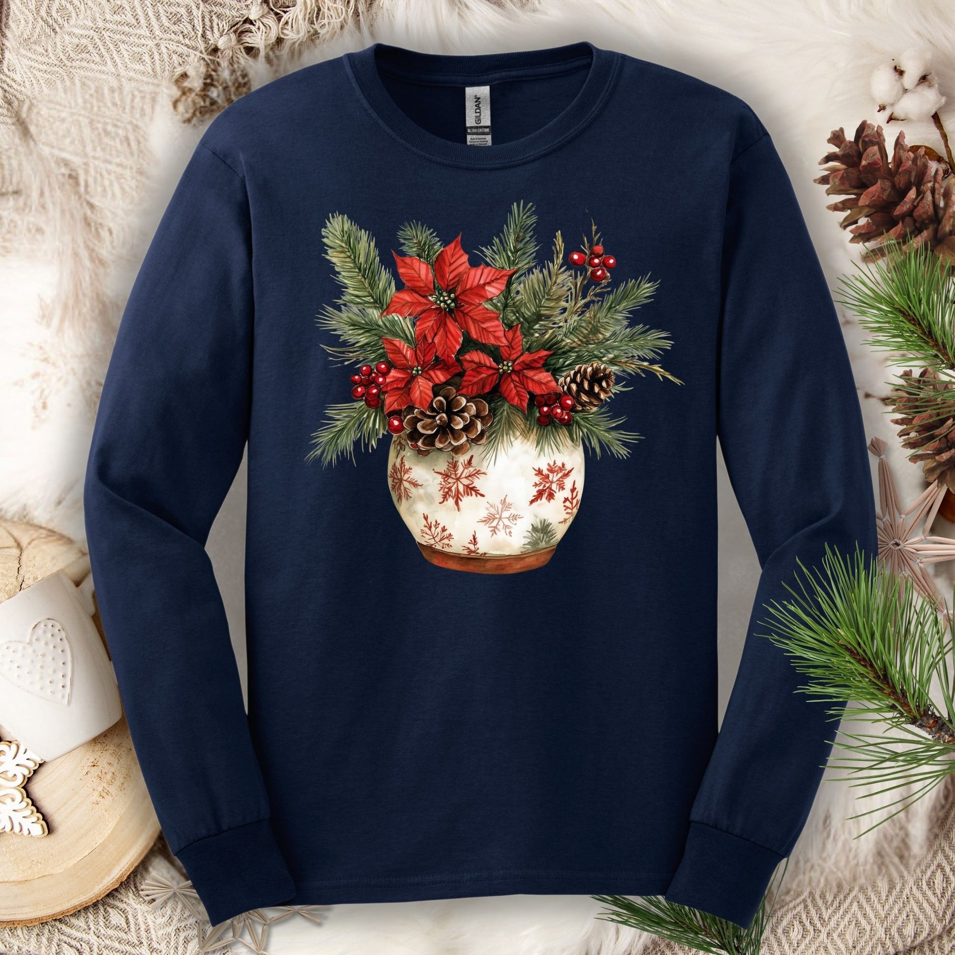 Navy long sleeve tee with a watercolor holiday floral arrangement in a snowflake ceramic pot.