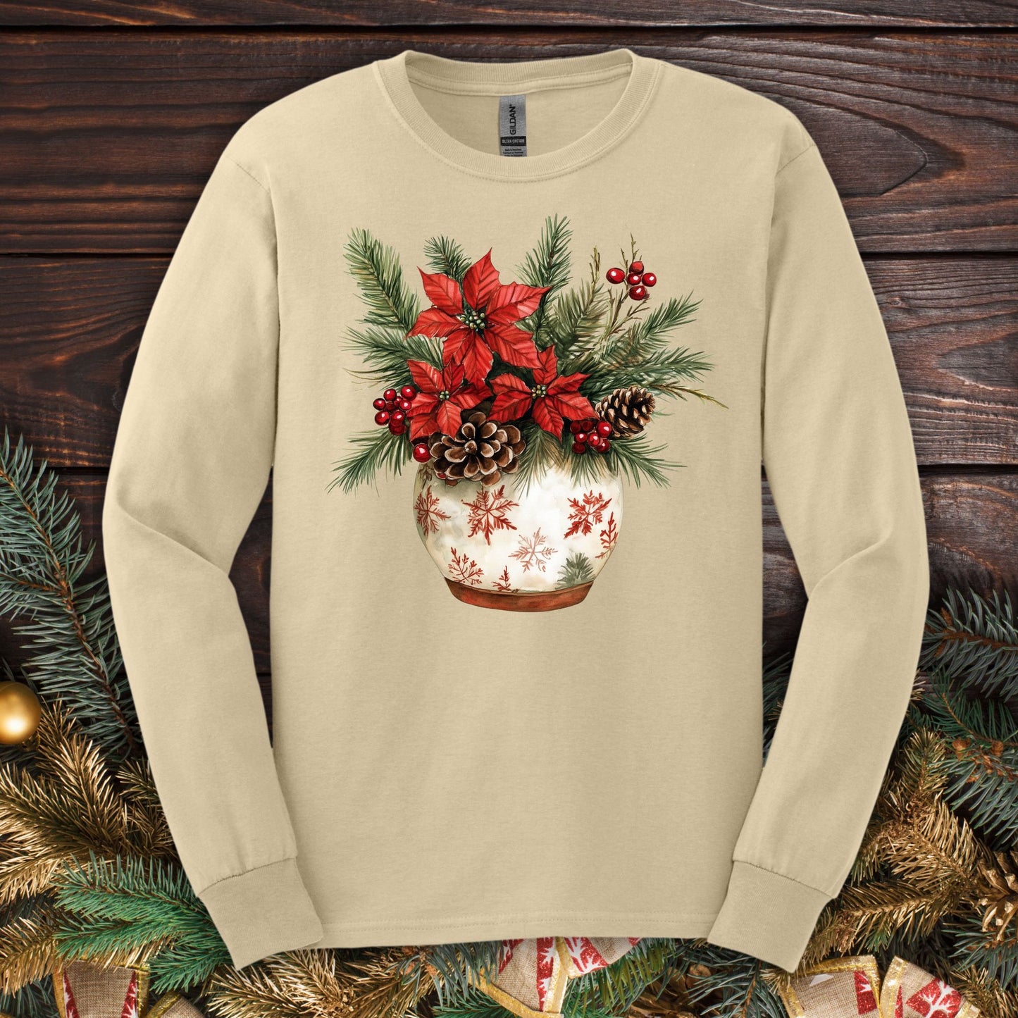 Sand Gildan long sleeve tee with a watercolor holiday floral arrangement in a snowflake ceramic pot.