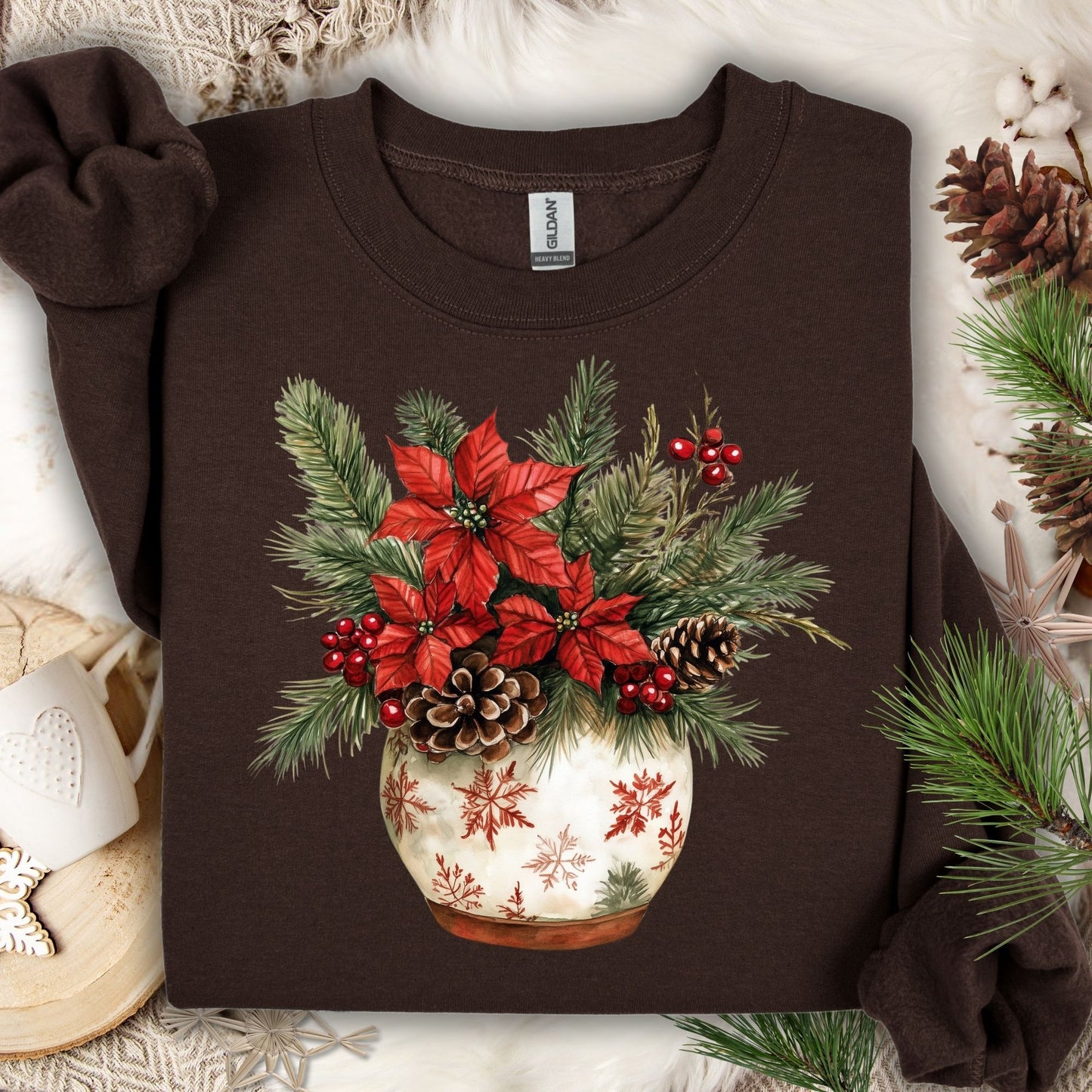 Dark Chocolate Gildan long sleeve sweatshirt with watercolor poinsettia, pinecone, and evergreen floral arrangement in a snowflake pot.